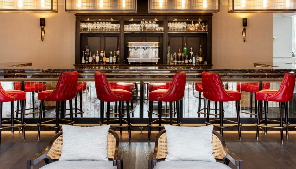 Red leather custom bar stools with lounge chairs at Wentworth Clubhouse