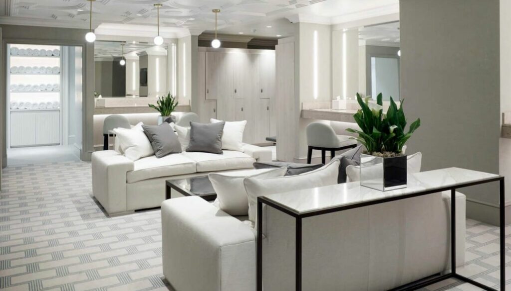 White bespoke sofas and lounge seating in a refined clubhouse relaxation area