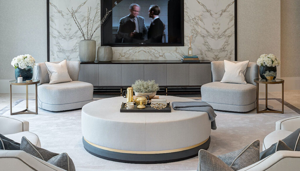 Curved bespoke lounge seating and upholstered ottoman in a Surrey residence