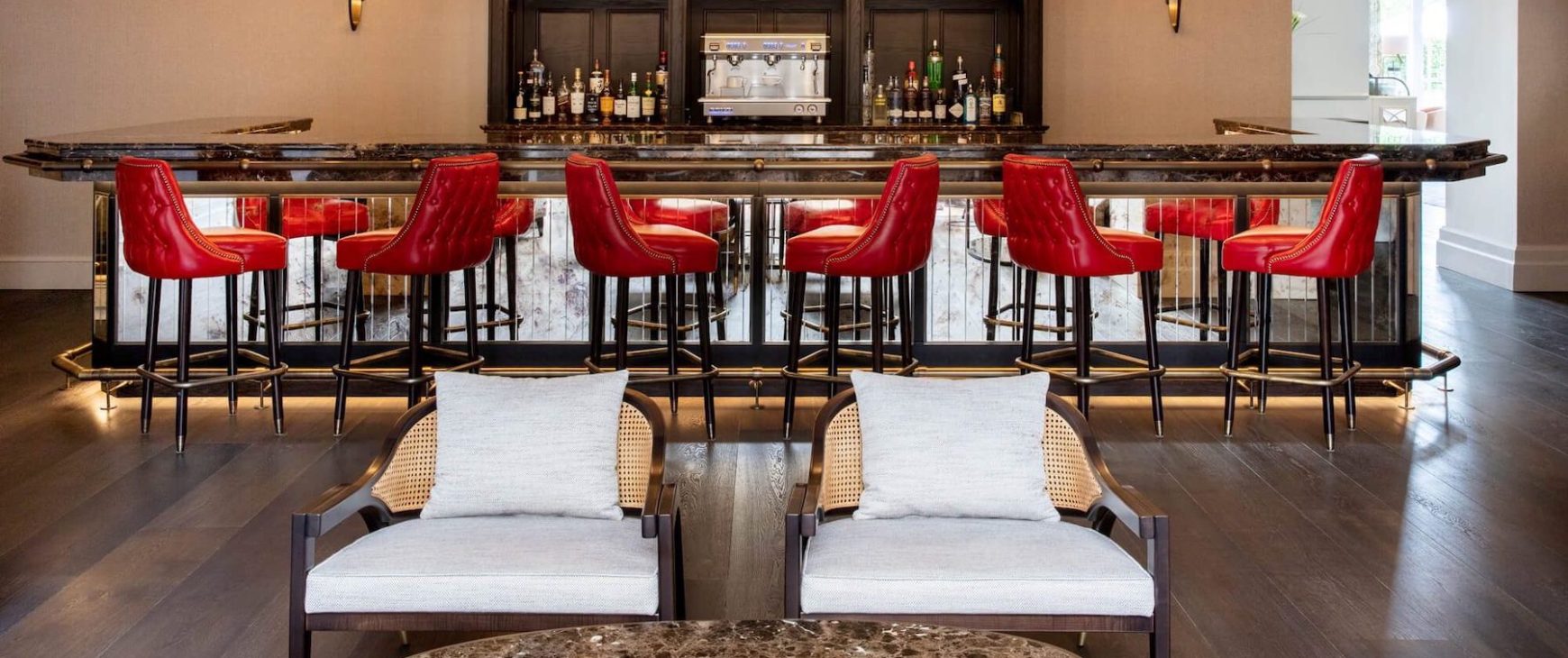Custom red leather bar stools and lounge chairs in a luxury hotel bar
